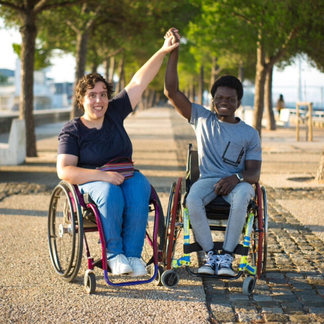 portrait biracial family romantic date park african american man caucasian woman wheelchairs holding hands smiling love relationship happiness concept