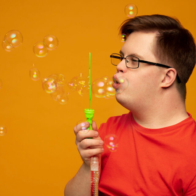 portrait disabled man with soap bubbles